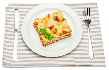 Portion of tasty lasagna isolated on white
