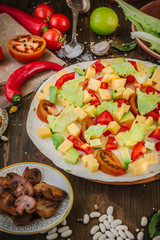 Tortilla with salad over it, surrounded by ingredients.