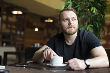 Successful intelligent business man relaxing in a luxury restaurant outdoors, confident thoughtful entrepreneur, wealthy men pensive rest and waiting someone in the modern coffee shop terrace
