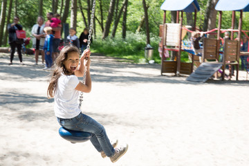 young girl make zip line in the park for children