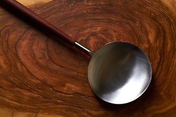 Modern stainless steel spoon spatula on wood