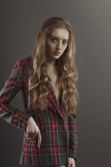 Splendid blonde woman posing for model tests  in checkered jacket