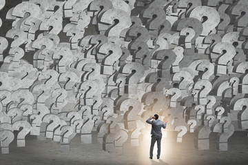 Businessman facing questions in business