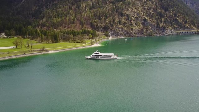 Aerial: following tourist boat on the Achensee in the Austrian Alps in 4K