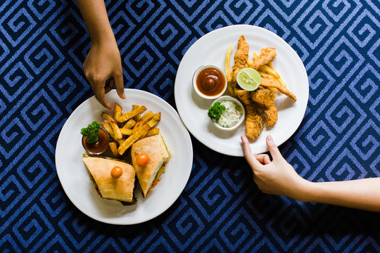 Hands picking snack on the table