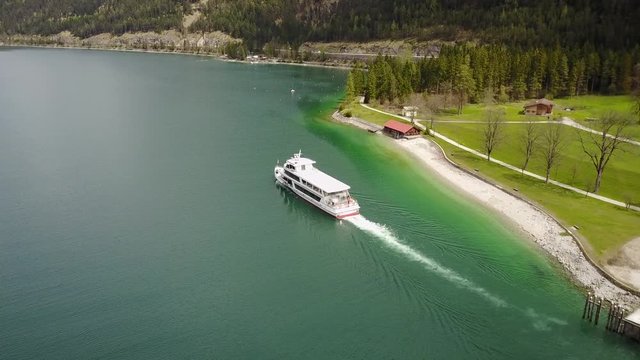 Aerial: following tourist boat on the Achensee in the Austrian Alps in 4K