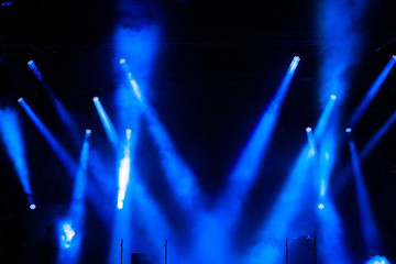 Stage light with colored spotlights and smoke.