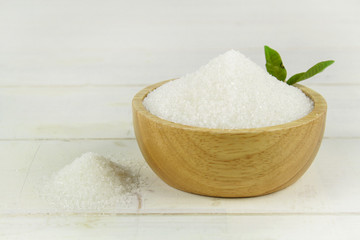 Sugar in wooden bowl isolated on white