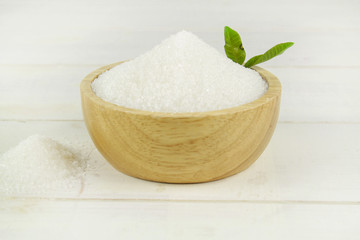 Sugar in wooden bowl isolated on white