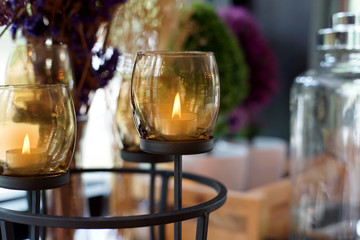 candles lit in brown glass