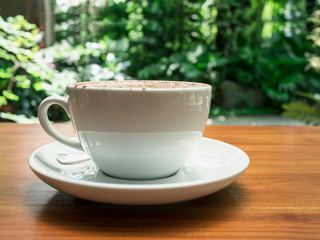 hot coffee cup on wood table.