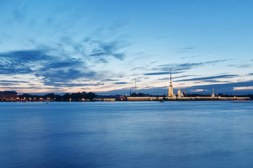 Obraz premium Night St .Petersburg, Russia. View on the Neva river Palace Bridge and Peter and Paul Fortress. Illumination and lights, dark blue sky