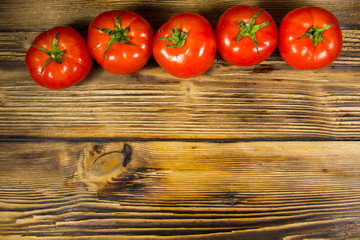 Ripe red tomatoes on wooden table