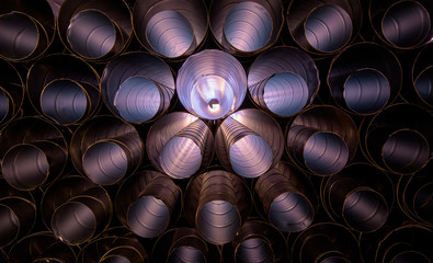 Aluminum HVAC Ducting piled up ready to use at a construction site creating an abstract pattern