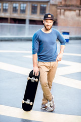Portrait of a man with skateboard © rh2010
