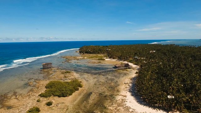 Viewpoint in the ocean at Cloud Nine surf point, Siargao island , Philippines. Aerial view raised wooden walkway for surfers to cross the reef of siargao island to cloud 9 surf break mindanao. Siargao