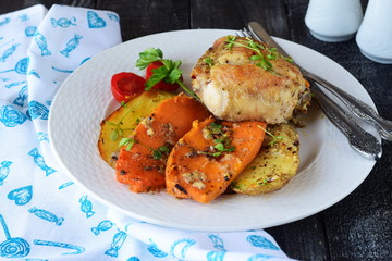 Oven cooked chicken with potato and sweet potato, spices , herbs in olive oil. Home cooking, healthy food concept