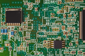 Microelectronic circuit board with components close up.