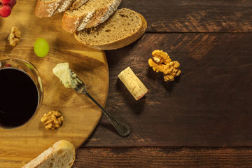 Glass of red wine, fork of blue cheese, copyspace