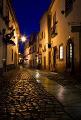 Naklejka premium On the street of medieval town of Obidos, Portugal at night