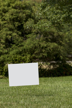 Blank white yard sign with a shallow depth of field 