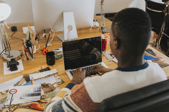 Photographer editing photos in the laptop