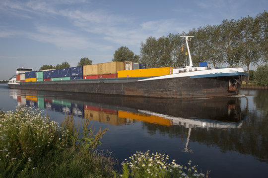 Riverbaot, barge with containers. Netherlands. Canal. Meppelerdiep. Container cargo ship.