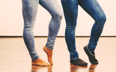 Female legs in denim pants and socks