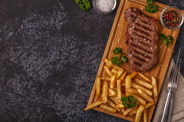 Beef barbecue steak with french fries.