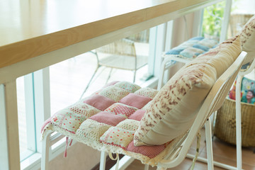 bar stool with pillow cushion flowers pattern interior decoration in cafe