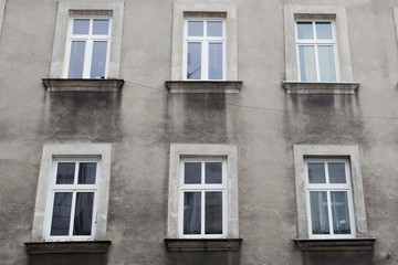 Fototapeta na wymiar Six windows on the facade of the gray house