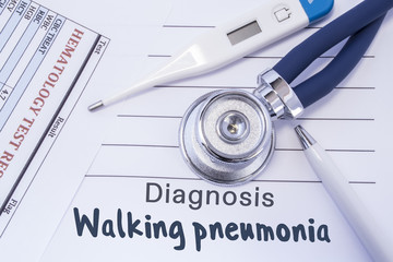 Diagnosis of walking pneumonia. Stethoscope, electronic thermometer, common blood test results are on medical form, which indicated diagnosis of walking pneumonia. Concept for internal medicine 