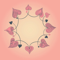 Circular pattern of red hearts on a pink background