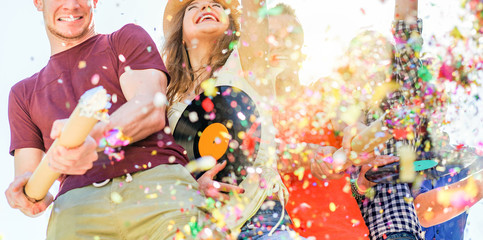 Fototapeta premium Group of happy friends enjoying party and throwing confetti