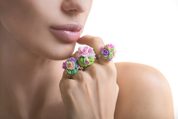 Romantic style: Fashion studio shot of beautiful woman with a floral ring (jewelery made of polymer...