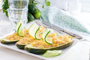 Zucchini stuffed with rice and chicken, decorated with fresh cucumber. Festive menu, horizontal