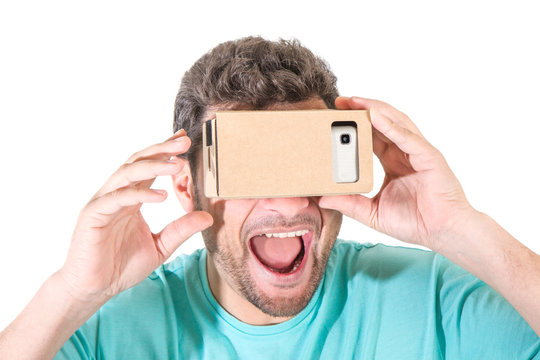 Man explores virtual reality using cardboard VR glasses