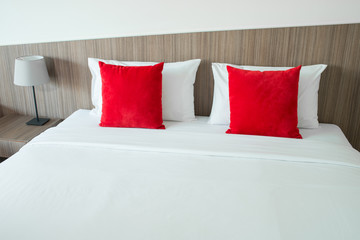 Red and white pillows on a bed