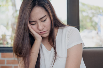 Close up image of an Asian woman with feeling tired