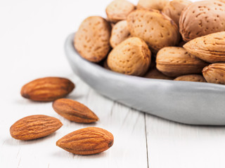 Almond on white wooden background