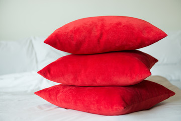 Red pillows on a bed