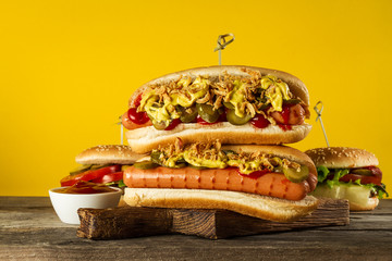 Tasty classic traditional hot dog on wooden board.