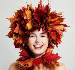 Autumn Woman Laughing. Fall Maple Leaves Wreath and Fashion Makeup
