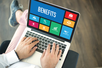 People using laptop in an office and BENEFITS concept on screen - 150566634