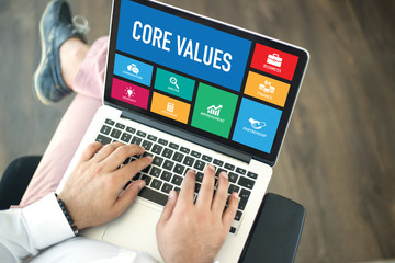 People using laptop in an office and CORE VALUES concept on screen