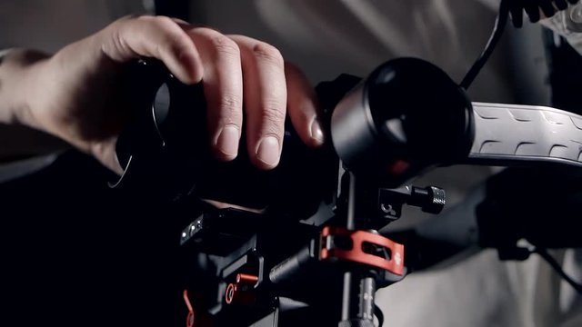 Hands of a master video equipment set up the stabilizer and camera for shooting video