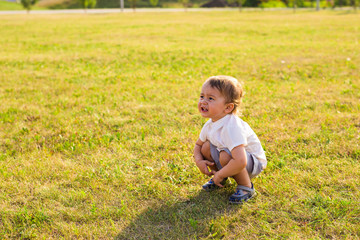 Summer, childhood and baby concept - little boy having fun in summer nature.