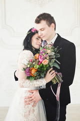 Beautiful Bride and Groom Hugging. Fashion Model Woman and Handsome Man Fall in Love. Wedding Couple