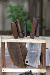 The old knives with rust on wood  stand.