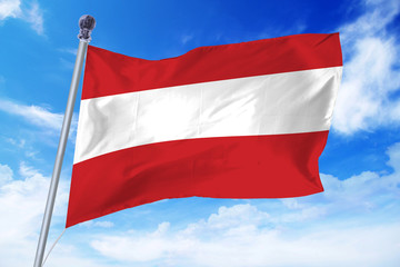Fototapeta na wymiar Flag of Austria developing against a clear blue sky